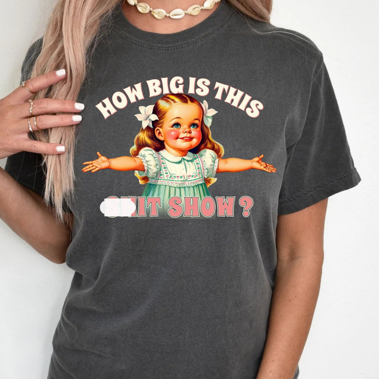 a woman wearing a t - shirt that says how big is this it show?