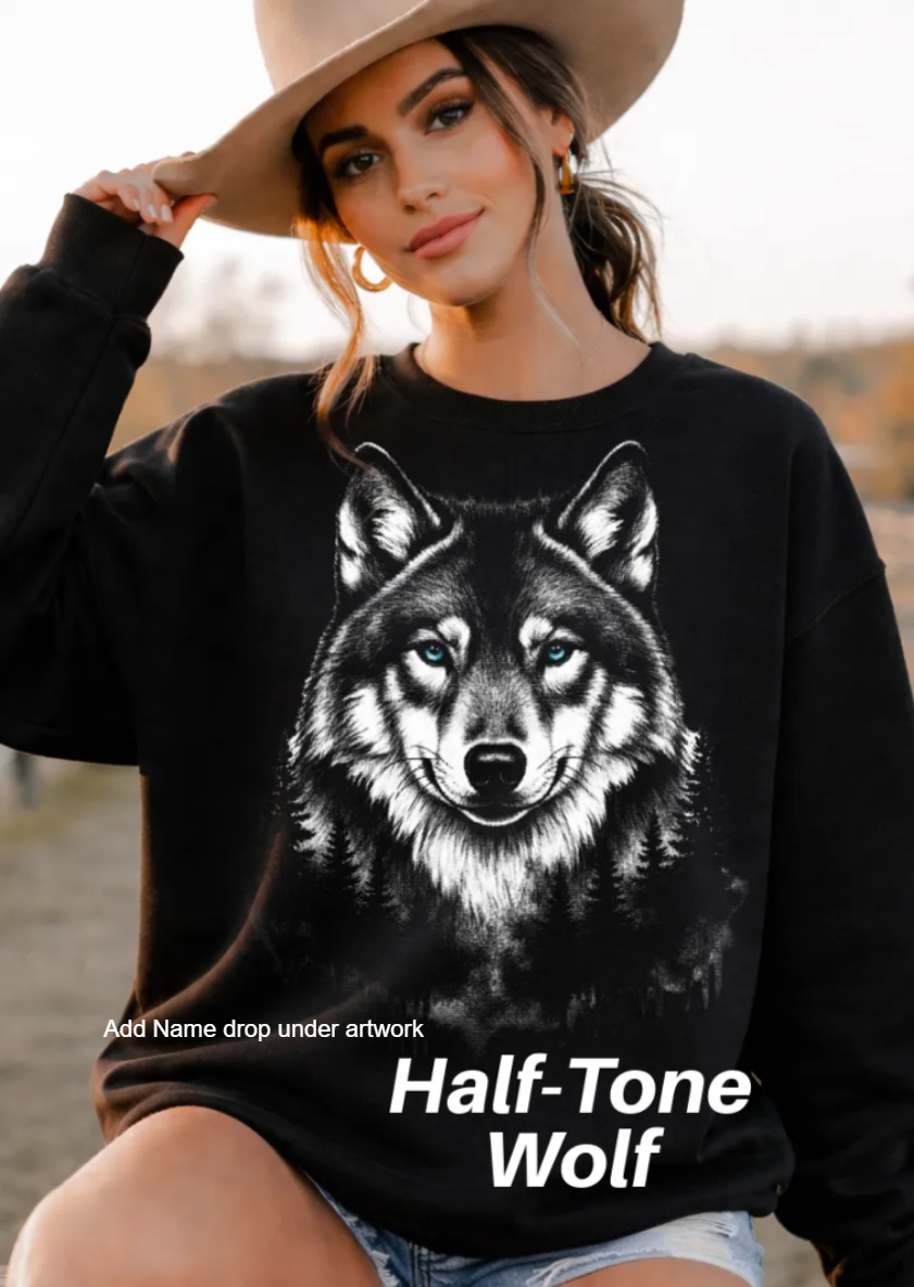 A woman wearing a black sweatshirt with a graphic of a wolf on it, posing outdoors.