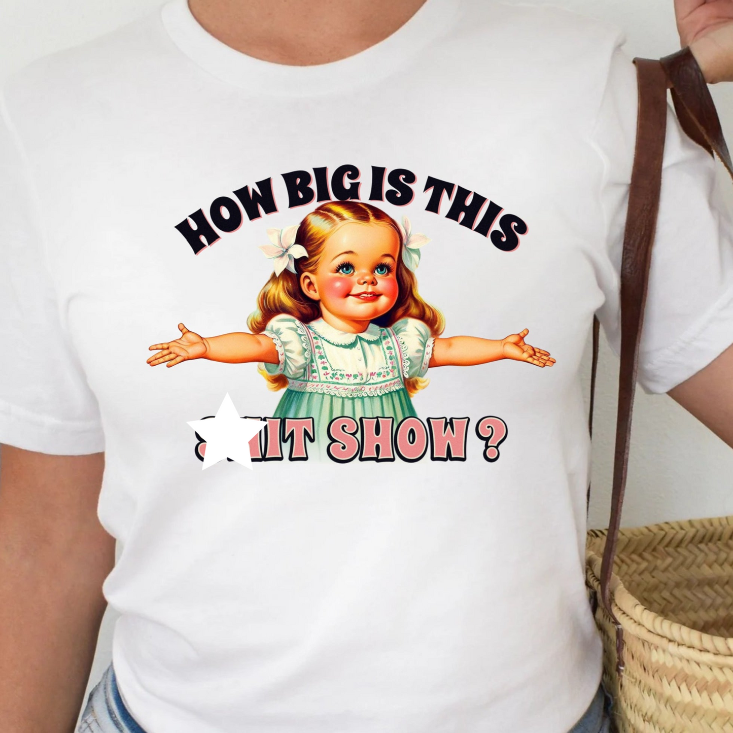 a woman wearing a t - shirt with a picture of a little girl on it