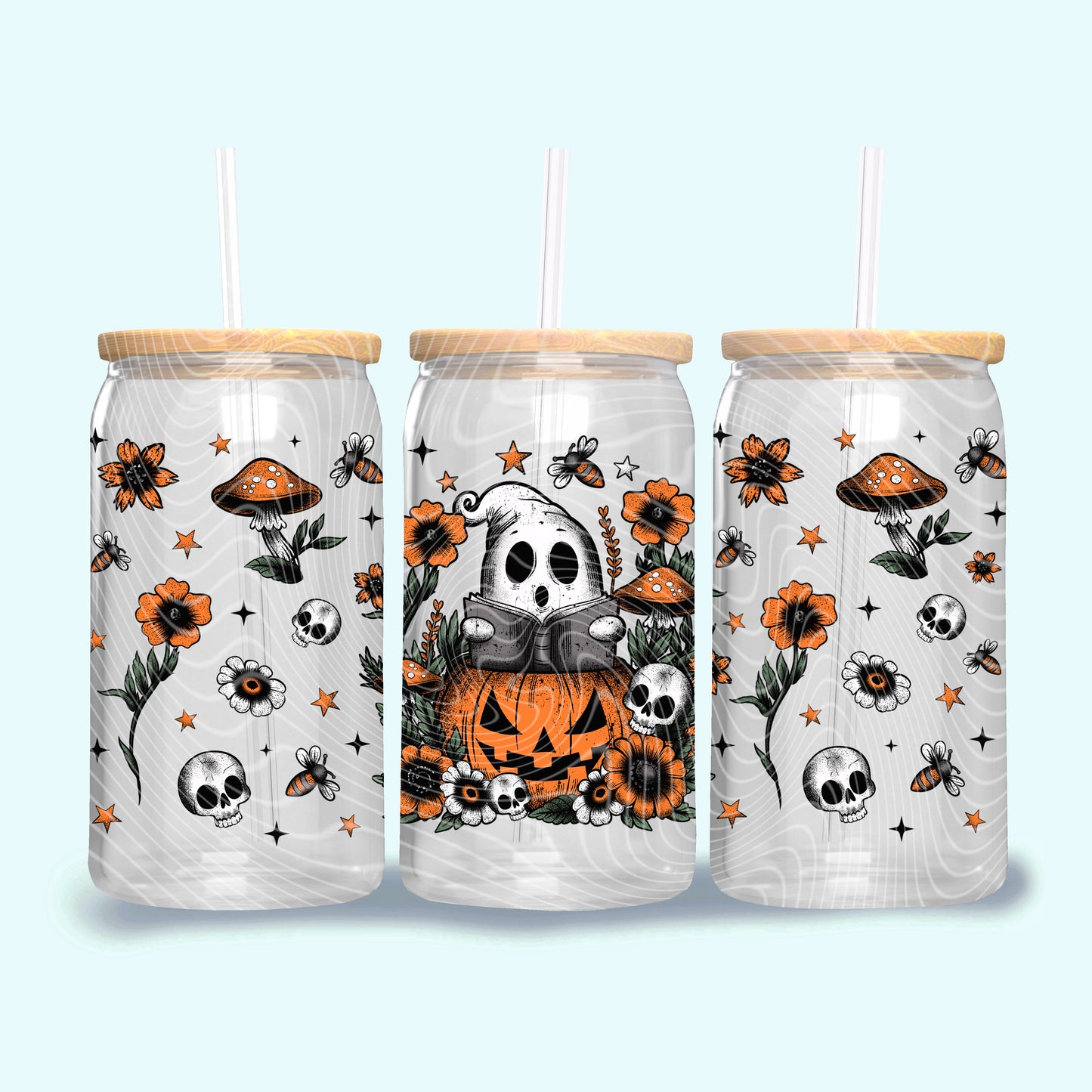 Three Halloween-themed tumblers with wooden lids on a light blue background