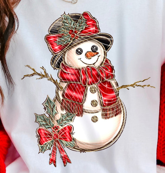 A screen print transfer or DTF transfer featuring a vintage design of a snowman with Christmas decorations and a red bow on a white background.