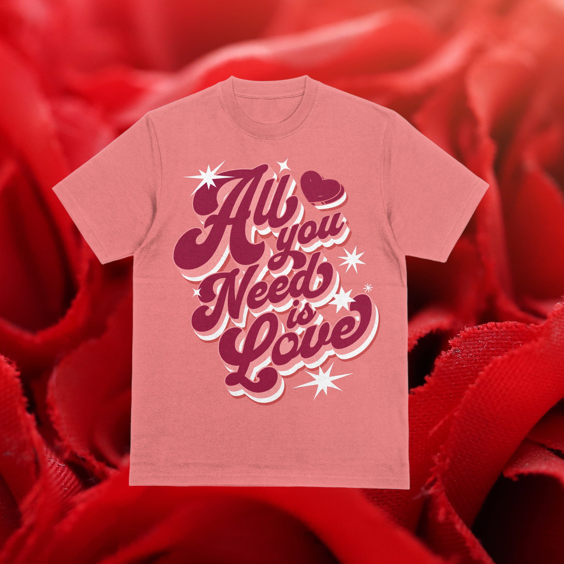 A pink DTF transfer with the text 'All You Need Is Love' and pink stars on a red background.
