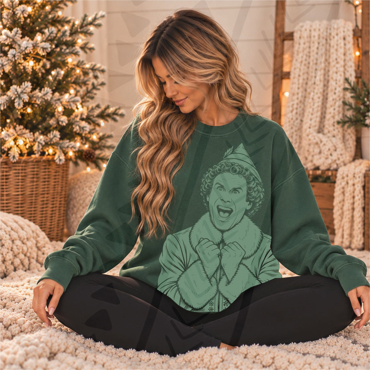 Green Buddy the Elf portrait with excited expression, elf hat and raised hands, shown on a forest-green sweatshirt; DTF transfer only, garment not included.