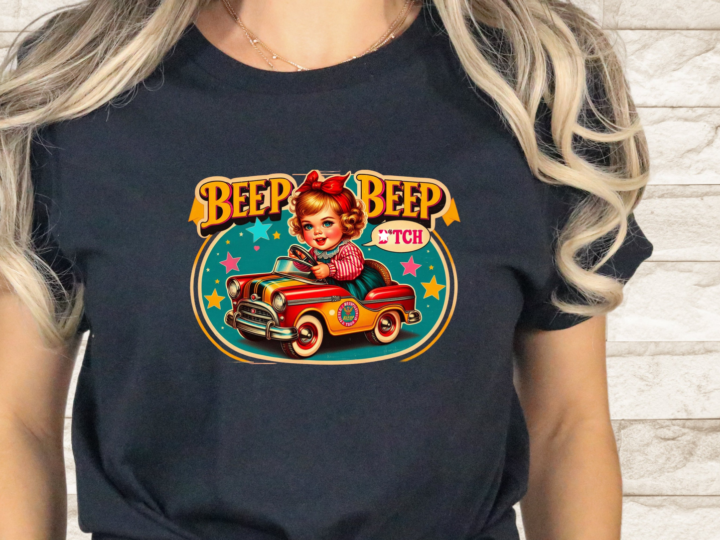 a woman wearing a black t - shirt with a picture of a woman driving a