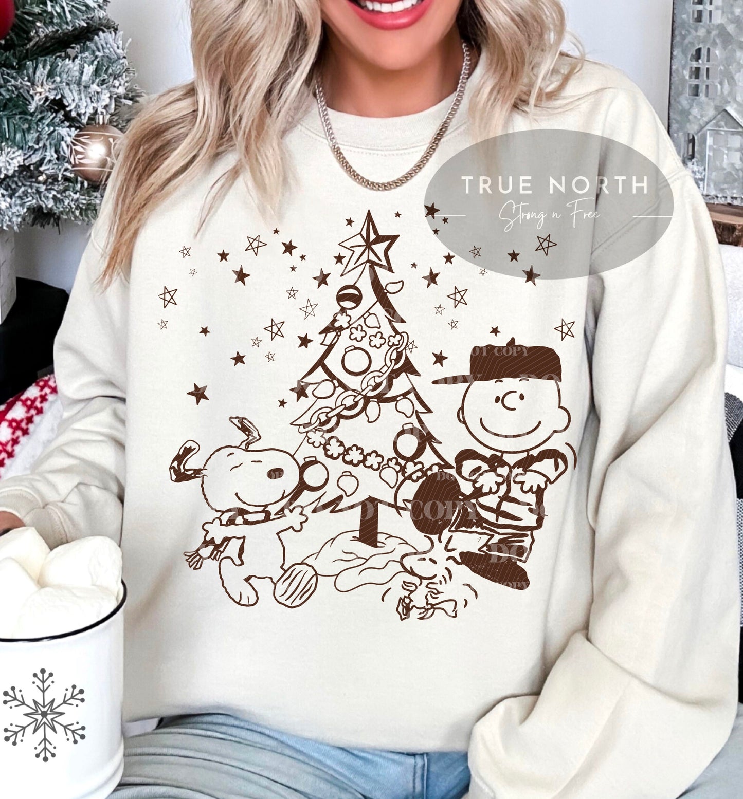 a woman sitting on a couch wearing a christmas sweater