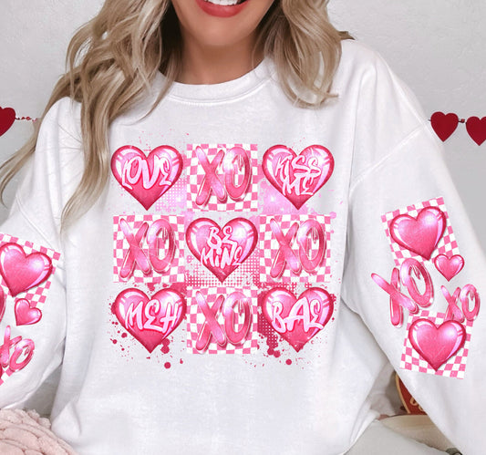 a woman wearing a white shirt with pink hearts on it