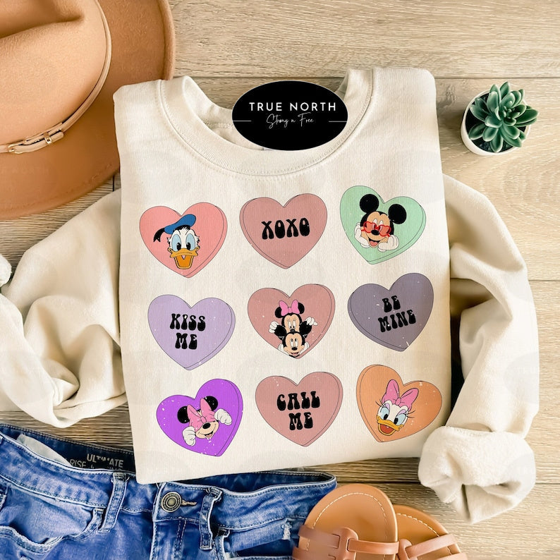 a white shirt with mickey mouse hearts on it