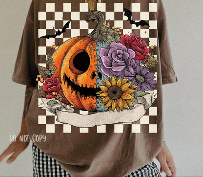 Brown t-shirt with a Halloween-themed design featuring a pumpkin, flowers, and checkered border.