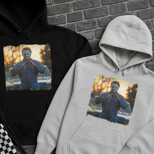 Black and gray hoodies with a printed design of a person in a blue shirt on a brick surface.