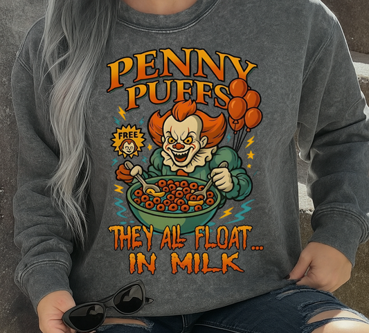 Person wearing a gray sweatshirt with 'Penny Puffs' graphic design, sitting on steps.