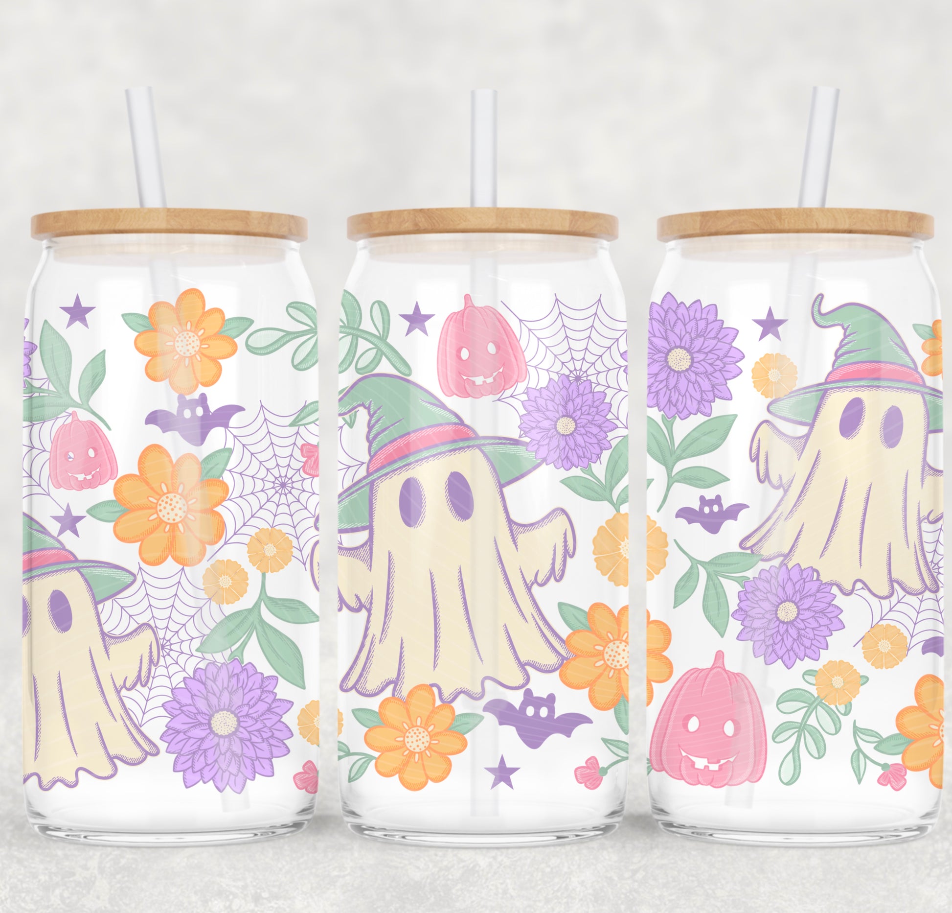 Three glass jars with Halloween-themed designs featuring ghosts, pumpkins, and flowers on a white background.