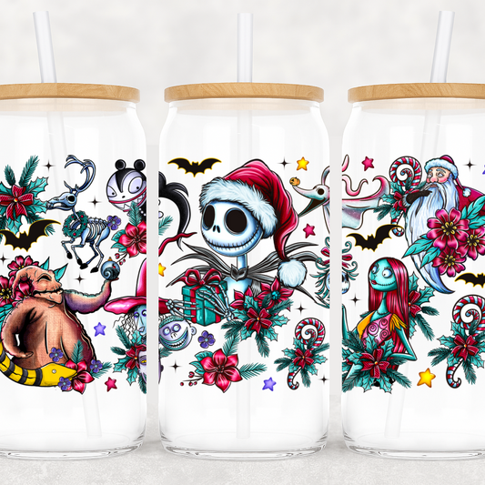 Three glass tumblers with festive designs featuring cartoon characters and holiday elements.