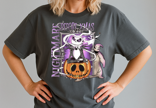 Person wearing a dark gray t-shirt with a Halloween-themed design, black cap, and sunglasses on a gray background.