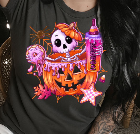 Person wearing a black t-shirt with a colorful Halloween-themed design.