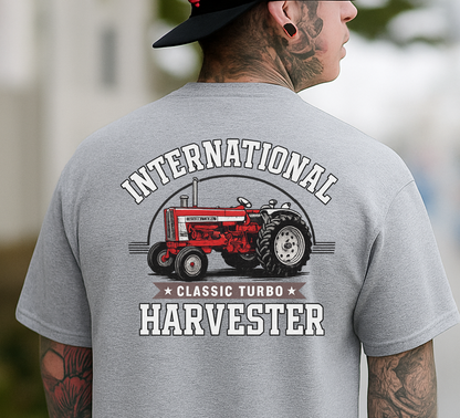 Person wearing a gray t-shirt with International Harvester logo on the back.