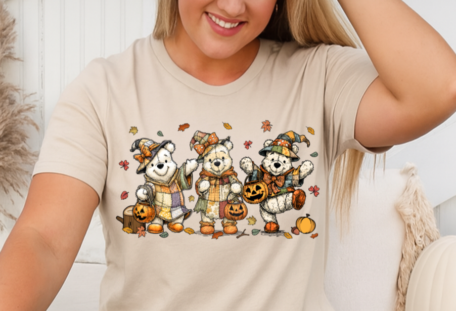 Woman wearing a beige t-shirt with cartoon dog graphics sitting on a wooden floor.