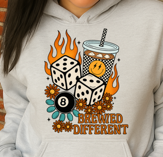 Person wearing a hoodie with a graphic design against a brick wall