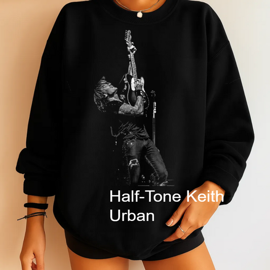 A black and white image of a person playing a guitar, with the text "Half-tone Keith Urban" below the image.