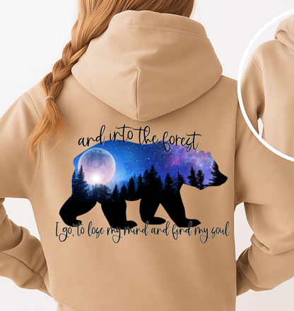 Beige hoodie with bear and forest design on the back, on a white background