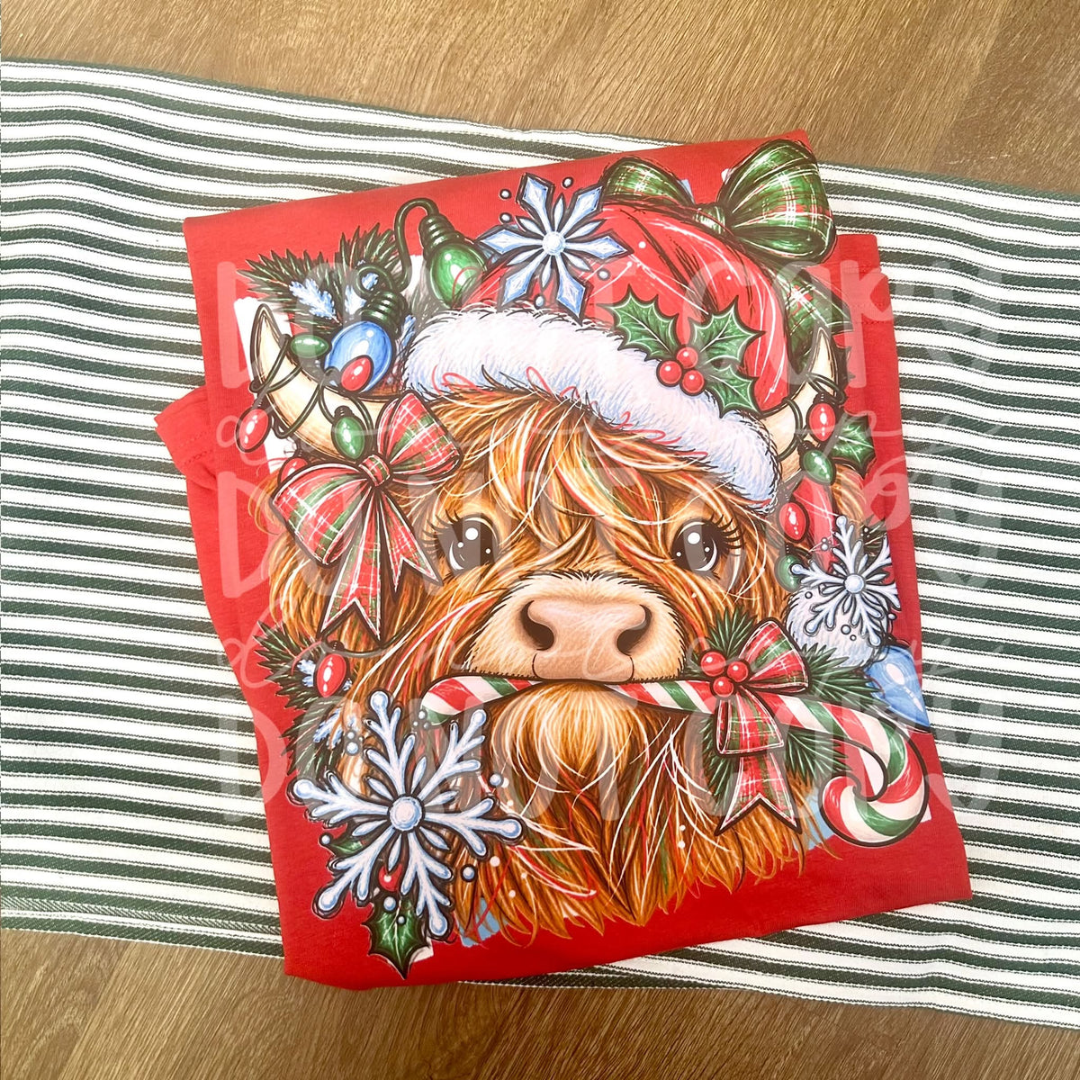 Festive Highland cow wearing a Santa hat and surrounded by Christmas bows, ornaments, snowflakes and candy cane. The original photo is multicolour; the Black and White choices refer to the ordered colour version.