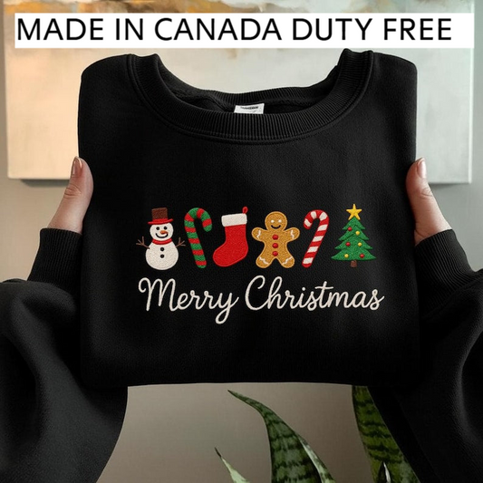 A person is holding up a black sweater with a festive Christmas design, including a snowman, gingerbread man, candy canes, and a Christmas tree. The sweater is labeled as "Made in Canada Duty Free".