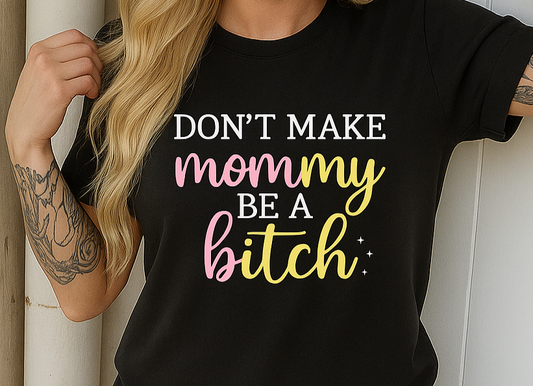 Woman wearing a black t-shirt with colorful text against a white wall.