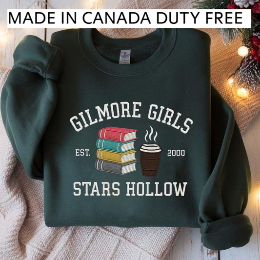 A dark green sweatshirt with a graphic design featuring a stack of books and a cup of coffee, along with text that reads "GILMORE GIRLS EST. 2000 STARS HOLLOW".