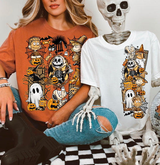 Two people wearing Halloween-themed t-shirts with cartoon characters, one in brown and one in white, sitting next to skeletons on a checkered floor.