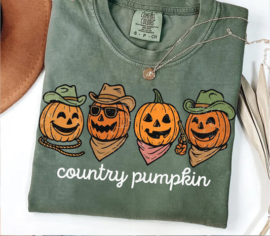 Green t-shirt with 'country pumpkin' design featuring pumpkins wearing hats and bandanas on a white background.