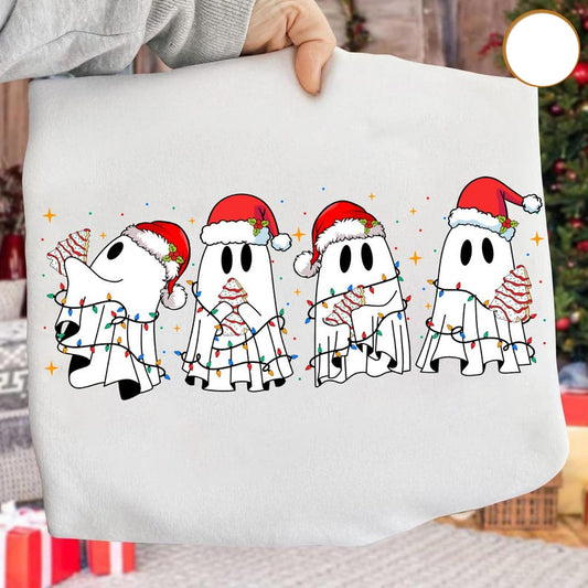 White pillow with Christmas-themed ghost design held by a person, with a blurred festive background.