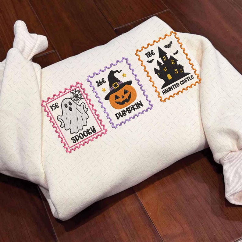 Folded embroidered Halloween sweatshirt with ghost, pumpkin and haunted castle stamps