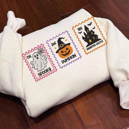Folded embroidered Halloween sweatshirt with ghost, pumpkin and haunted castle stamps