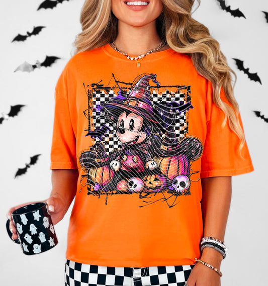 Person wearing an orange Halloween-themed t-shirt with a cartoon character, holding a black mug with ghost patterns, against a white background with black bats.