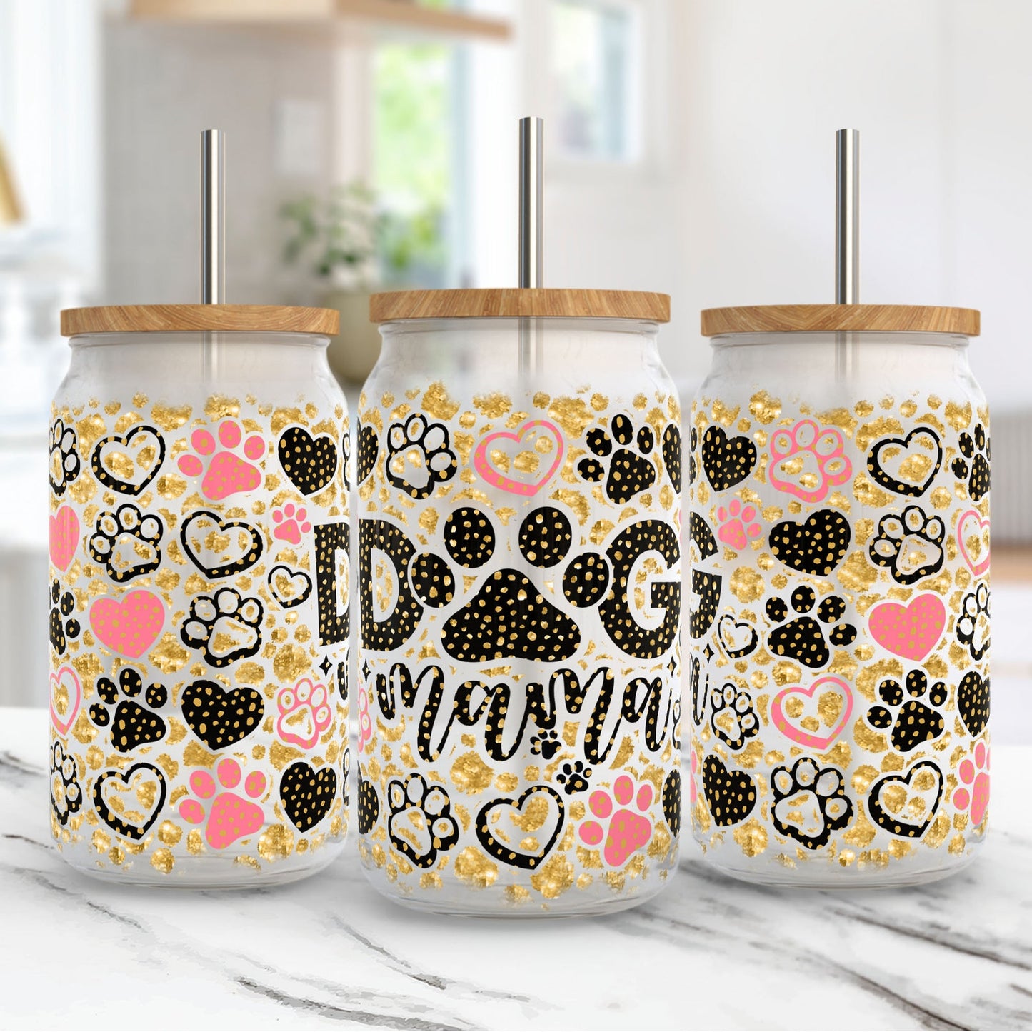 Three tumblers with paw print designs and 'Dog Mom' text on a marble surface.