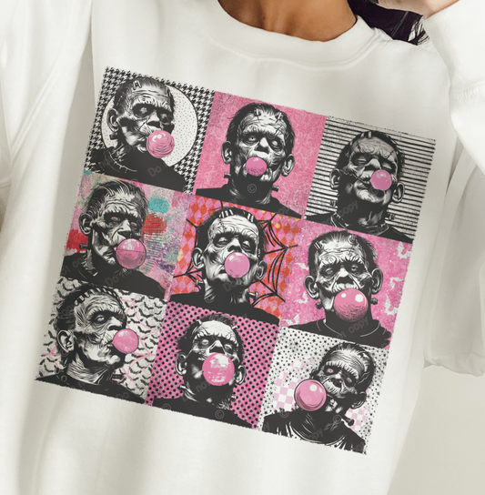 A graphic t-shirt with multiple images of a character resembling Frankenstein's monster, each with a bubble gum bubble in their mouth, set against a black and pink checkered background.