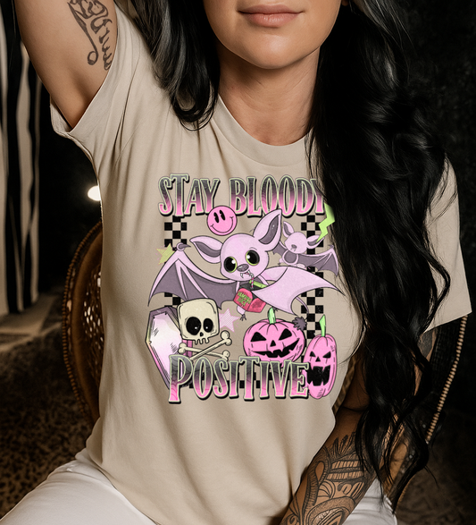 Person wearing a beige t-shirt with a graphic design and text.