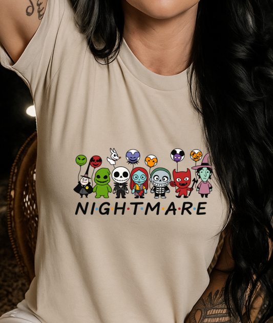 Person wearing a beige t-shirt with cartoon character designs and 'Nightmare' text.