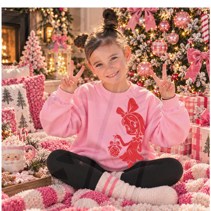 Red Cindy Lou Who holding a Christmas ornament DTF transfer, shown on a youth pink sweatshirt; garment not included.