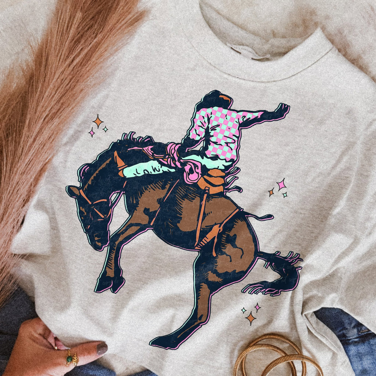Retro pink and turquoise cowgirl riding a bucking horse