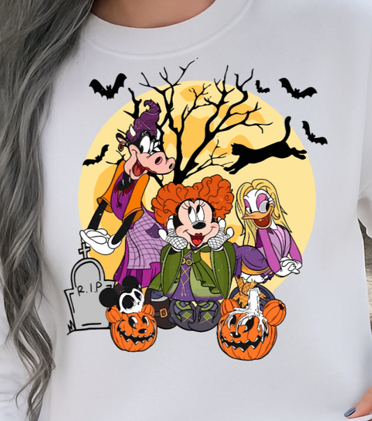 Person wearing a white sweatshirt with Halloween-themed cartoon design, sitting on steps.
