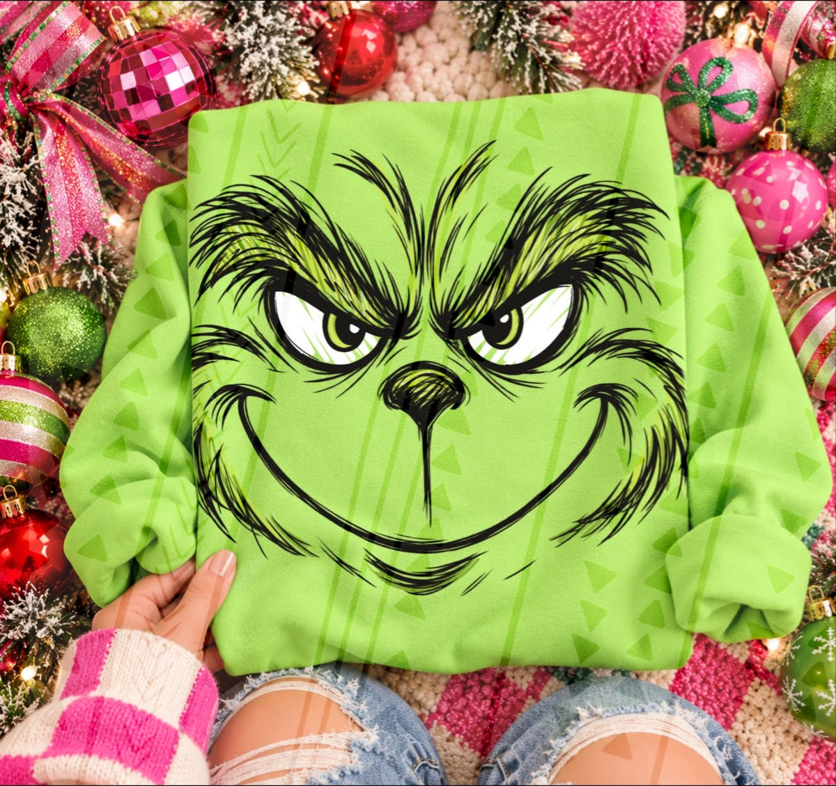 Grinch mischievous face DTF transfer shown on a green garment