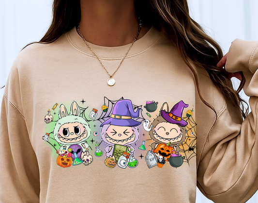 Beige sweatshirt with cartoon character design worn by a person against a white background
