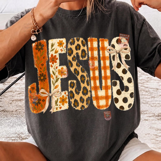Jesus autumn patterned-letter DTF transfer shown on a charcoal T-shirt