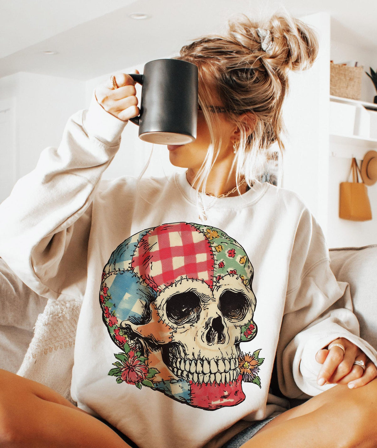 Patchwork floral skull DTF transfer shown on a cream sweatshirt