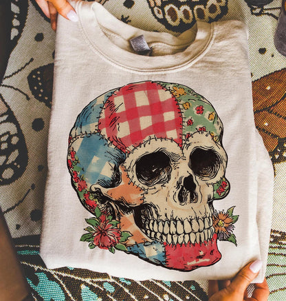 Folded cream sweatshirt with patchwork floral skull transfer
