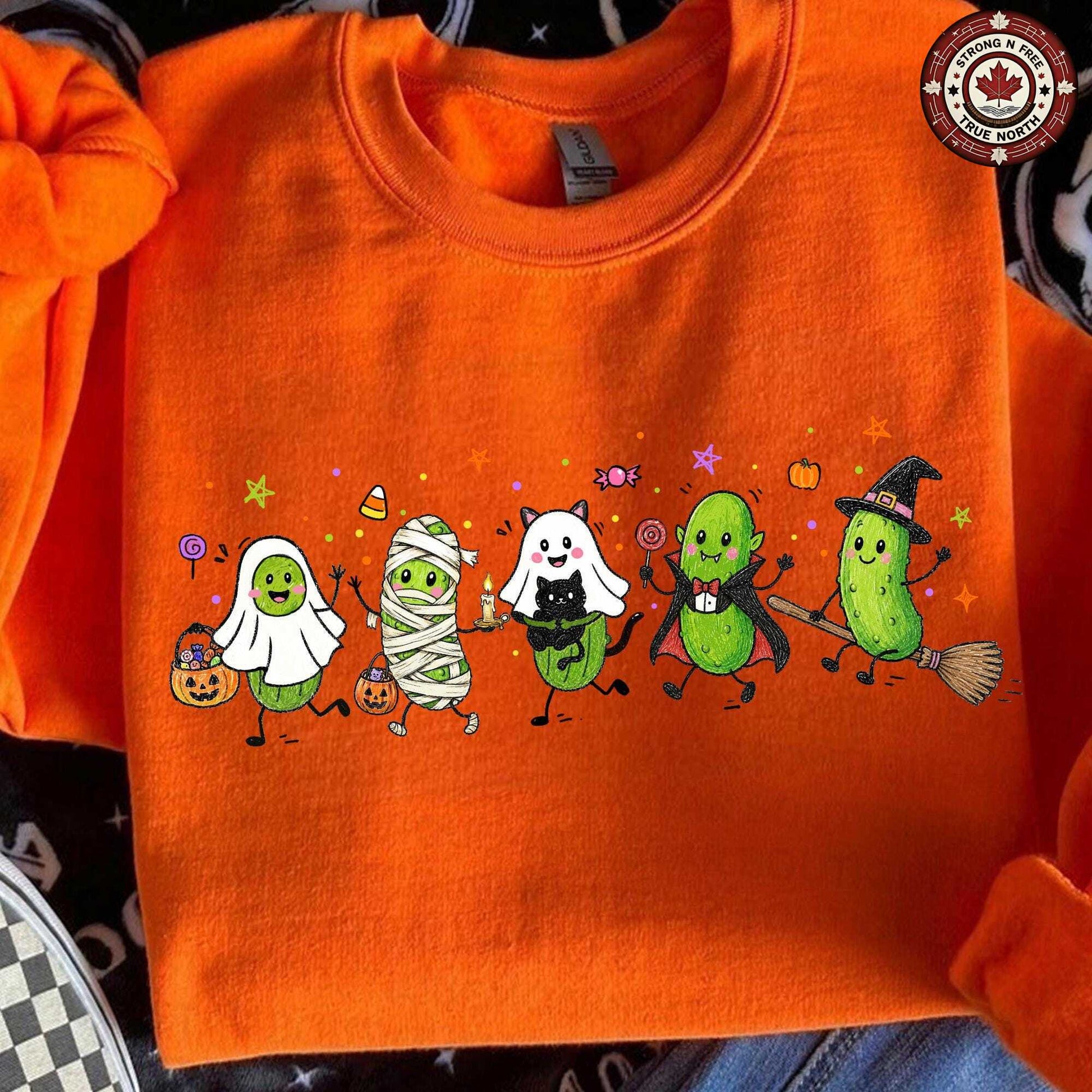 Funny Halloween pickle characters DTF transfer on an orange sweatshirt