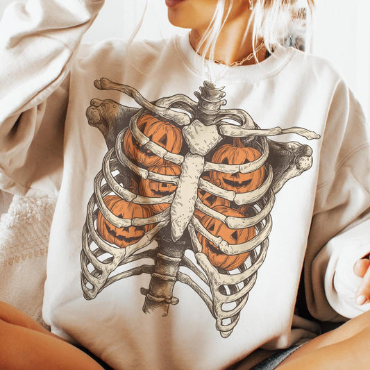 Ribcage pumpkins Halloween DTF transfer shown on a cream sweatshirt