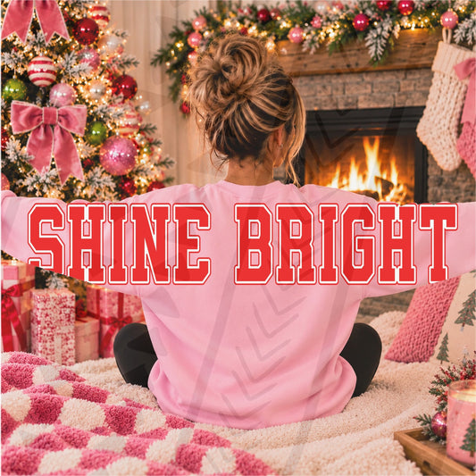 SHINE BRIGHT red varsity lettering with white outline across the back and sleeves of a pink sweatshirt; DTF transfer only