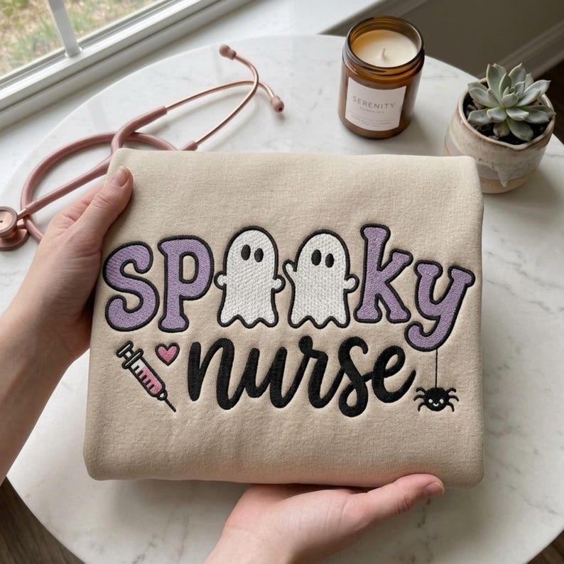 Spooky Nurse embroidery design on a finished cream sweatshirt
