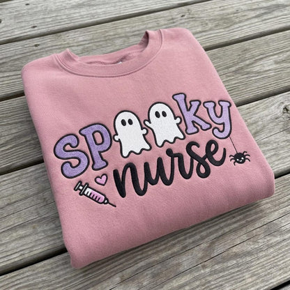 Spooky Nurse embroidery design on a finished pink sweatshirt